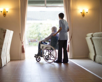 Nurse pushing patient in wheelchair